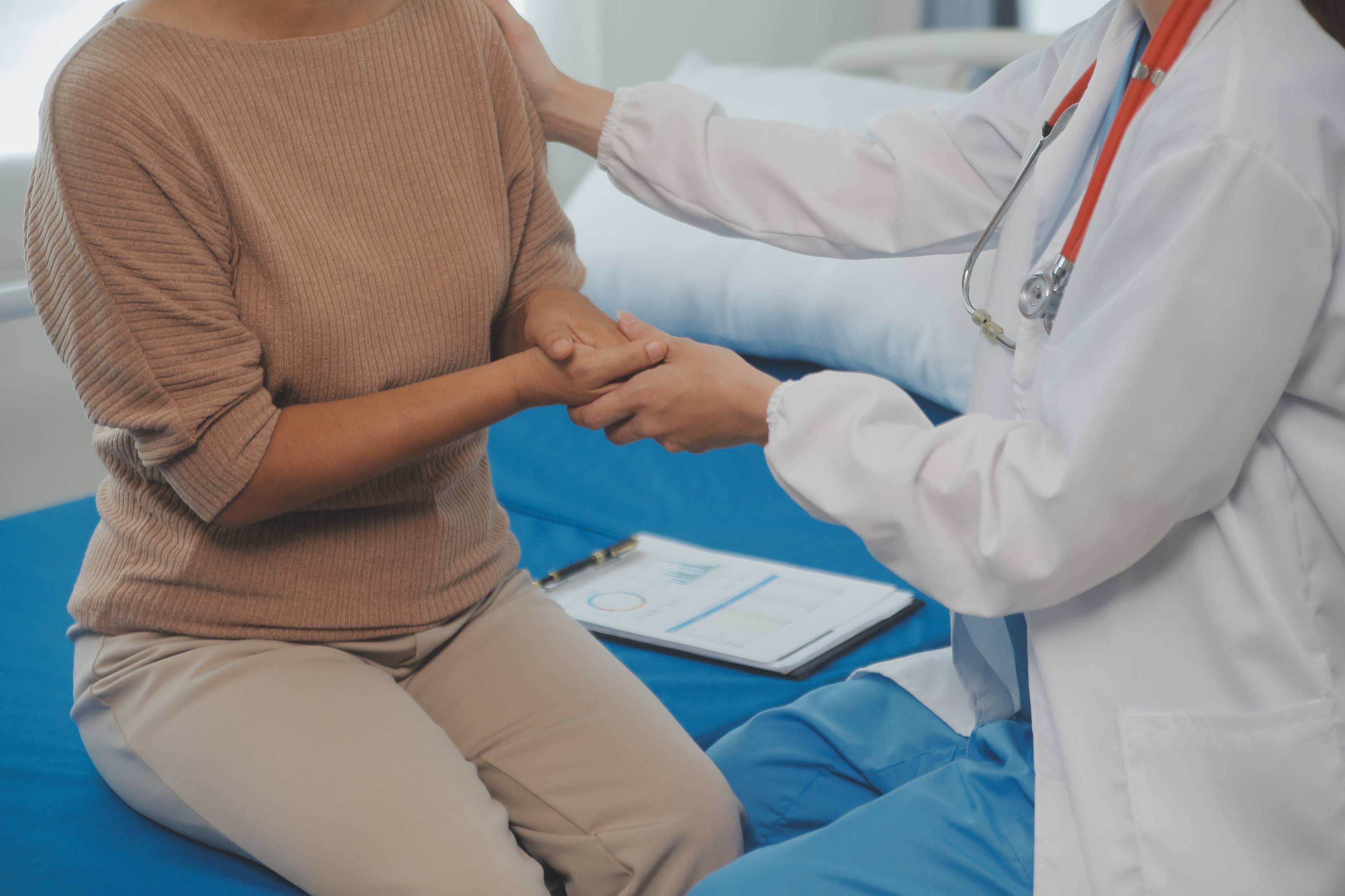 Young doctor is using a stethoscope listen to the heartbeat of the patient. Shot of a female doctor giving a male patient a check up