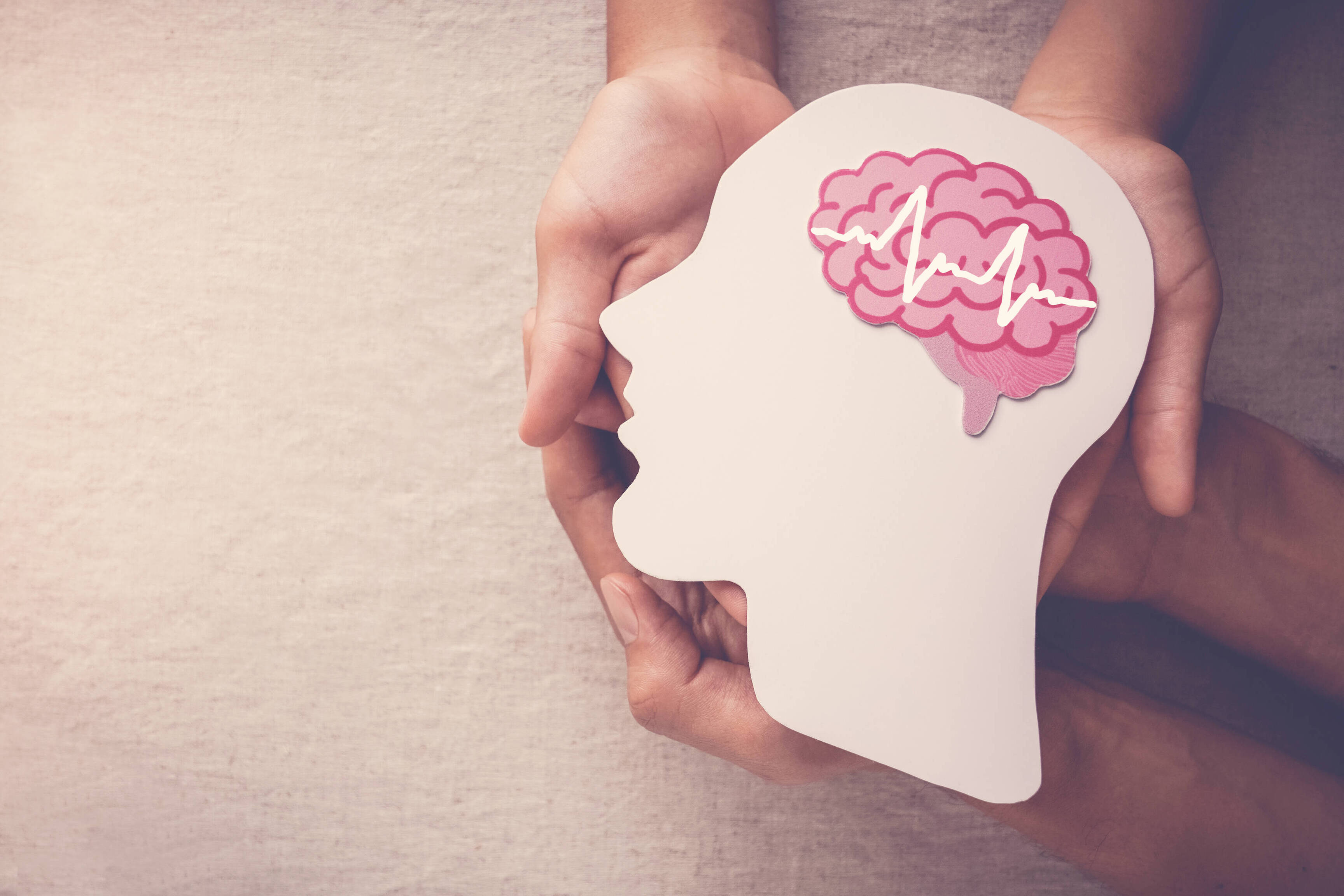 Adult and child hands holding encephalography brain paper cutout,autism, Stroke, Epilepsy and alzheimer awareness, seizure disorder, stroke, ADHD, world mental health day concept